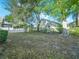 Landscaped backyard with mature trees and partial fence at 341 Lake Suzanne Dr, Lake Wales, FL 33859