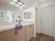 Clean bathroom with light wood vanity and large mirror at 341 Lake Suzanne Dr, Lake Wales, FL 33859