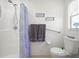 Bathroom with shower, toilet and grab bars at 341 Lake Suzanne Dr, Lake Wales, FL 33859