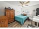 Charming bedroom with teal bedding and a wooden dresser at 341 Lake Suzanne Dr, Lake Wales, FL 33859