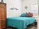 Simple bedroom with teal bedding and a wooden wardrobe at 341 Lake Suzanne Dr, Lake Wales, FL 33859