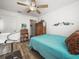 Comfortable bedroom featuring a teal comforter and ceiling fan at 341 Lake Suzanne Dr, Lake Wales, FL 33859