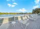 Relaxing lakefront deck with chaise lounges and gazebo at 341 Lake Suzanne Dr, Lake Wales, FL 33859