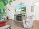 Living room with rustic-style fireplace and TV showing house exterior at 341 Lake Suzanne Dr, Lake Wales, FL 33859