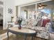 Relaxing living room with floral sofa and coffee table near sliding glass doors at 341 Lake Suzanne Dr, Lake Wales, FL 33859
