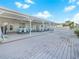 Covered pool deck with tables and chairs for outdoor relaxation at 341 Lake Suzanne Dr, Lake Wales, FL 33859