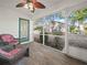 Relaxing screened patio with wicker chairs and wood-look flooring at 341 Lake Suzanne Dr, Lake Wales, FL 33859