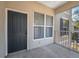 Balcony with a gray door and windows with white curtains at 5011 Hemingway Cir # 5011, Haines City, FL 33844