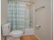 Clean and bright bathroom with shower/tub combo and wood-look tile floors at 5011 Hemingway Cir # 5011, Haines City, FL 33844