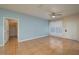 Spacious bedroom with wood-look tile flooring, ceiling fan, and access to closet at 5011 Hemingway Cir # 5011, Haines City, FL 33844