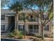 Attractive two-story condo building with balconies, palm trees, and lush landscaping at 5011 Hemingway Cir # 5011, Haines City, FL 33844