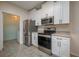 Well-equipped kitchen featuring stainless steel appliances, white cabinets, and ample counter space at 5011 Hemingway Cir # 5011, Haines City, FL 33844