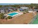 Community pool with lounge chairs, tennis court, and surrounding buildings at 5011 Hemingway Cir # 5011, Haines City, FL 33844