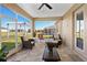 Relaxing screened porch with wicker furniture and a view of the backyard at 807 Lake Marie Dr, Dundee, FL 33838