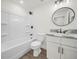 Modern bathroom featuring a white tub/shower, marble countertop, and black fixtures at 815 S Seminole Ave, Fort Meade, FL 33841