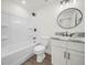 Bathroom with white vanity, marble countertop and bathtub at 815 S Seminole Ave, Fort Meade, FL 33841