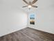 Well-lit bedroom with wood-look floors and ceiling fan at 815 S Seminole Ave, Fort Meade, FL 33841