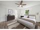 Spacious bedroom with large window, ceiling fan, and hardwood floors at 815 S Seminole Ave, Fort Meade, FL 33841