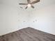 Spacious bedroom with wood-look flooring, white walls, and a ceiling fan at 815 S Seminole Ave, Fort Meade, FL 33841