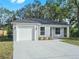Newly built one-story house featuring a white garage door and concrete driveway at 815 S Seminole Ave, Fort Meade, FL 33841