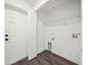 Laundry room with white walls, wood-look flooring, and wire shelving at 815 S Seminole Ave, Fort Meade, FL 33841