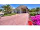 Tan house with covered entry and pavered driveway at 337 Motorcoach S Dr, Polk City, FL 33868