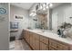Double vanity bathroom with a large mirror and updated light fixtures at 337 Motorcoach S Dr, Polk City, FL 33868