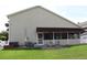 House exterior showcasing a covered patio and well-manicured lawn at 337 Motorcoach S Dr, Polk City, FL 33868