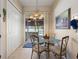 Casual breakfast nook with glass-top table and chairs, adjacent to sliding doors leading to a screened patio at 337 Motorcoach S Dr, Polk City, FL 33868