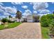 House exterior featuring a paver driveway, landscaping and attached garage at 336 Cruisers Dr, Polk City, FL 33868