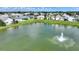 Community lake view with fountain and surrounding homes at 336 Cruisers Dr, Polk City, FL 33868