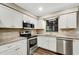Modern kitchen with stainless steel appliances and granite countertops at 7510 Catherine Dr, Lakeland, FL 33810