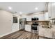 Renovated kitchen, featuring stainless steel appliances and granite countertops at 7510 Catherine Dr, Lakeland, FL 33810