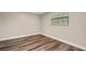 Spacious bedroom featuring wood-look floors and large window at 7510 Catherine Dr, Lakeland, FL 33810