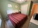 King-size bedroom with striped bedding and a ceiling fan at 8425 Crystal Cove Loop, Kissimmee, FL 34747