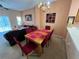 Dining area with table and six red chairs at 8425 Crystal Cove Loop, Kissimmee, FL 34747