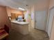 Kitchen with wood cabinets, white appliances, and breakfast bar at 8425 Crystal Cove Loop, Kissimmee, FL 34747