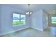 Bright dining area with a chandelier and view to backyard at 1413 Leamington Ln, Winter Haven, FL 33884