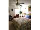 A bedroom with a bed, chair, and ceiling fan at 4773 Nw 32Nd St, Ocala, FL 34482