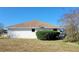 Rear view of a single-story house with a well-maintained lawn at 4773 Nw 32Nd St, Ocala, FL 34482