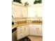 White kitchen cabinets and granite countertops at 4773 Nw 32Nd St, Ocala, FL 34482