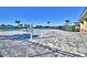 Resort-style pool with paver deck, lush landscaping, and lake views at 1492 Leamington Ln, Winter Haven, FL 33884