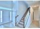 Two-story entryway with neutral color tile and a wooden staircase at 1492 Leamington Ln, Winter Haven, FL 33884