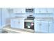 Modern kitchen featuring stainless steel appliances and white cabinetry at 1492 Leamington Ln, Winter Haven, FL 33884