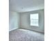 Simple bedroom with carpeted floor and window at 1492 Leamington Ln, Winter Haven, FL 33884