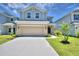 Two-story house with a neutral color scheme and a two-car garage at 1492 Leamington Ln, Winter Haven, FL 33884