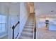 Staircase leading to the second floor, with kitchen view at 1417 Leamington Ln, Winter Haven, FL 33884