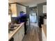 Open kitchen with white cabinets, stainless steel appliances and an island at 50989 Highway 27 # 230, Davenport, FL 33897