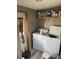 Bright laundry room with washer, dryer, and storage shelves at 50989 Highway 27 # 230, Davenport, FL 33897