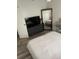 Bedroom with dresser, large mirror and wood-look flooring at 50989 Highway 27 # 230, Davenport, FL 33897